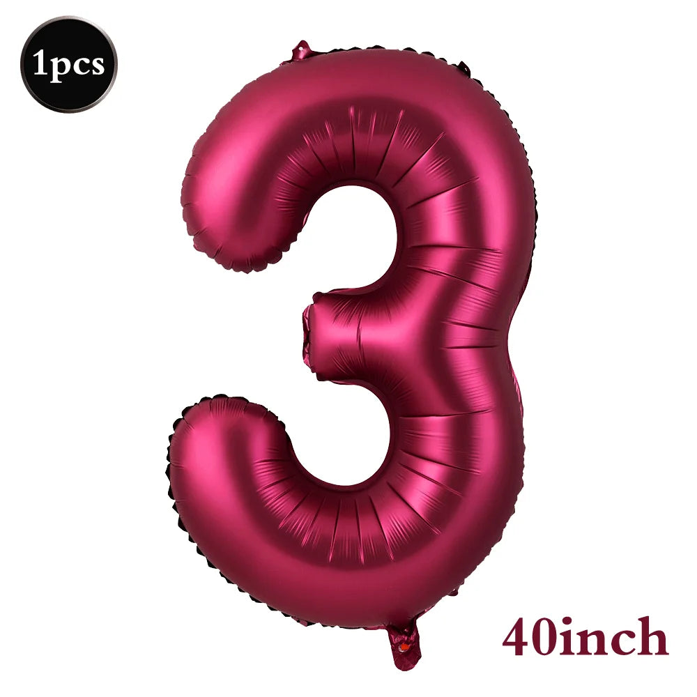 A single, large, metallic pink foil number balloon shaped like the number three.