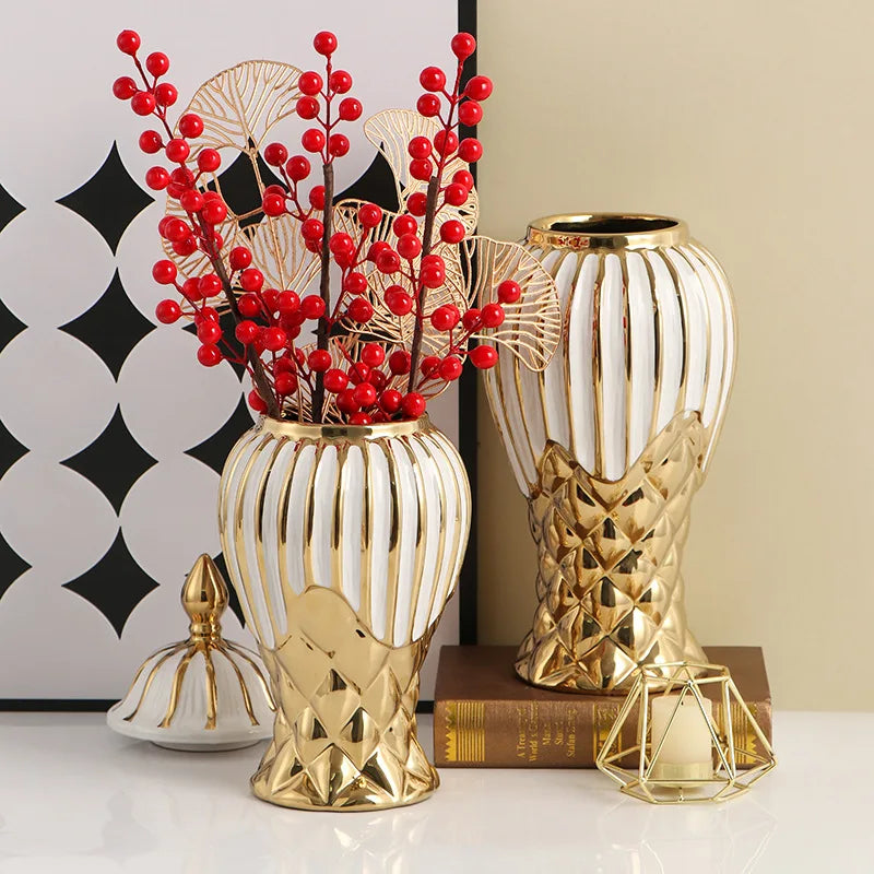 A gold and white ceramic decorative vase featuring red berries and fan-like accents.