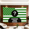 A green and white American flag tapestry featuring a large black question mark, displayed on a wooden wall.