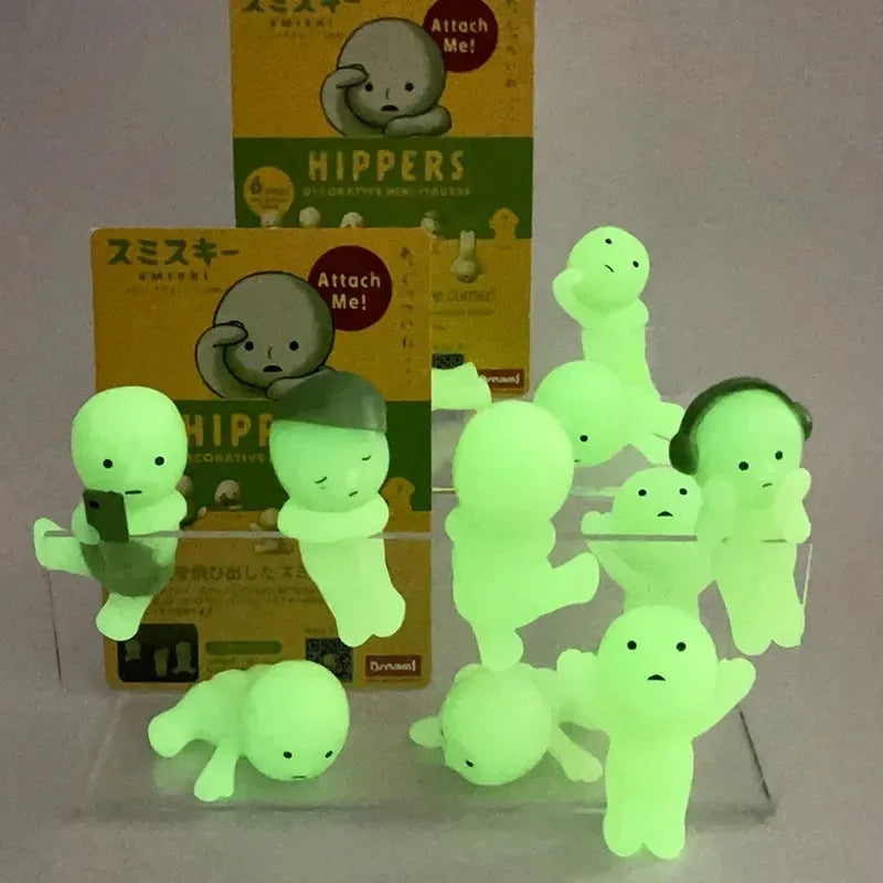 A collection of glow-in-the-dark anime animal blind box figures in various shades of green and yellow.