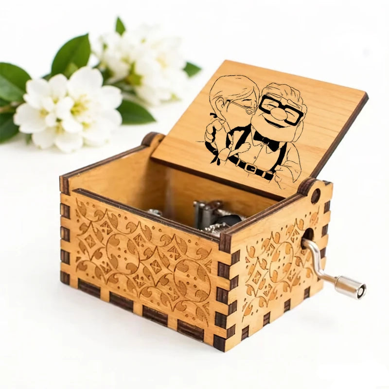 A hand-cranked wooden music box featuring an illustration of a married couple carved into the lid.