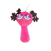 A pink plush toy with purple eyes and black hair accessories.