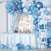 A blue latex balloon garland kit displayed on a table with white draping and a decorative backdrop.
