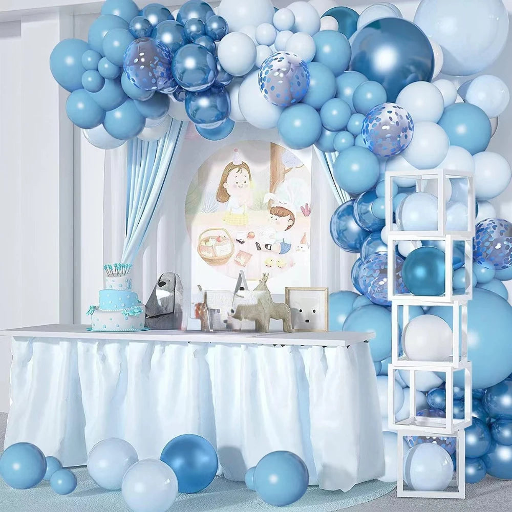 A blue latex balloon garland kit displayed on a table with white draping and a decorative backdrop.