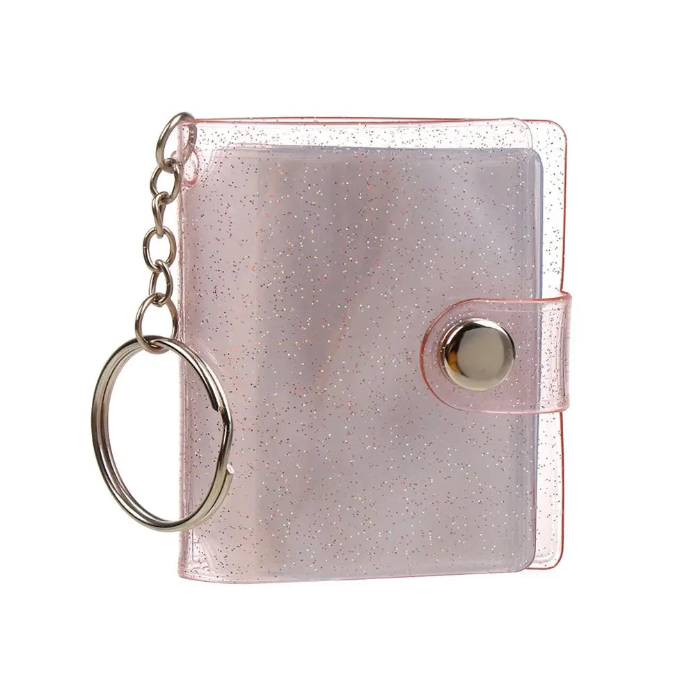 A pink glitter photo album with a silver chain and a snap closure.