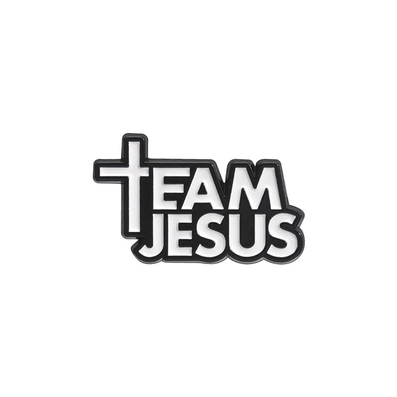 Black enamel pin featuring the text TEAM JESUS with a cross design.