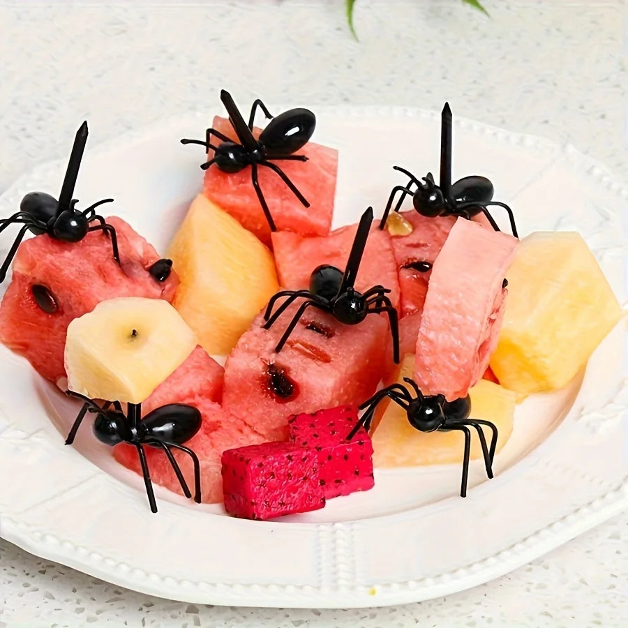 Ant-shaped plastic toothpicks and fruit forks used for serving party snacks like watermelon and fruit.