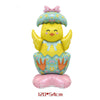A yellow cartoon chick with a floral hat and patterned body sits on a pink base.