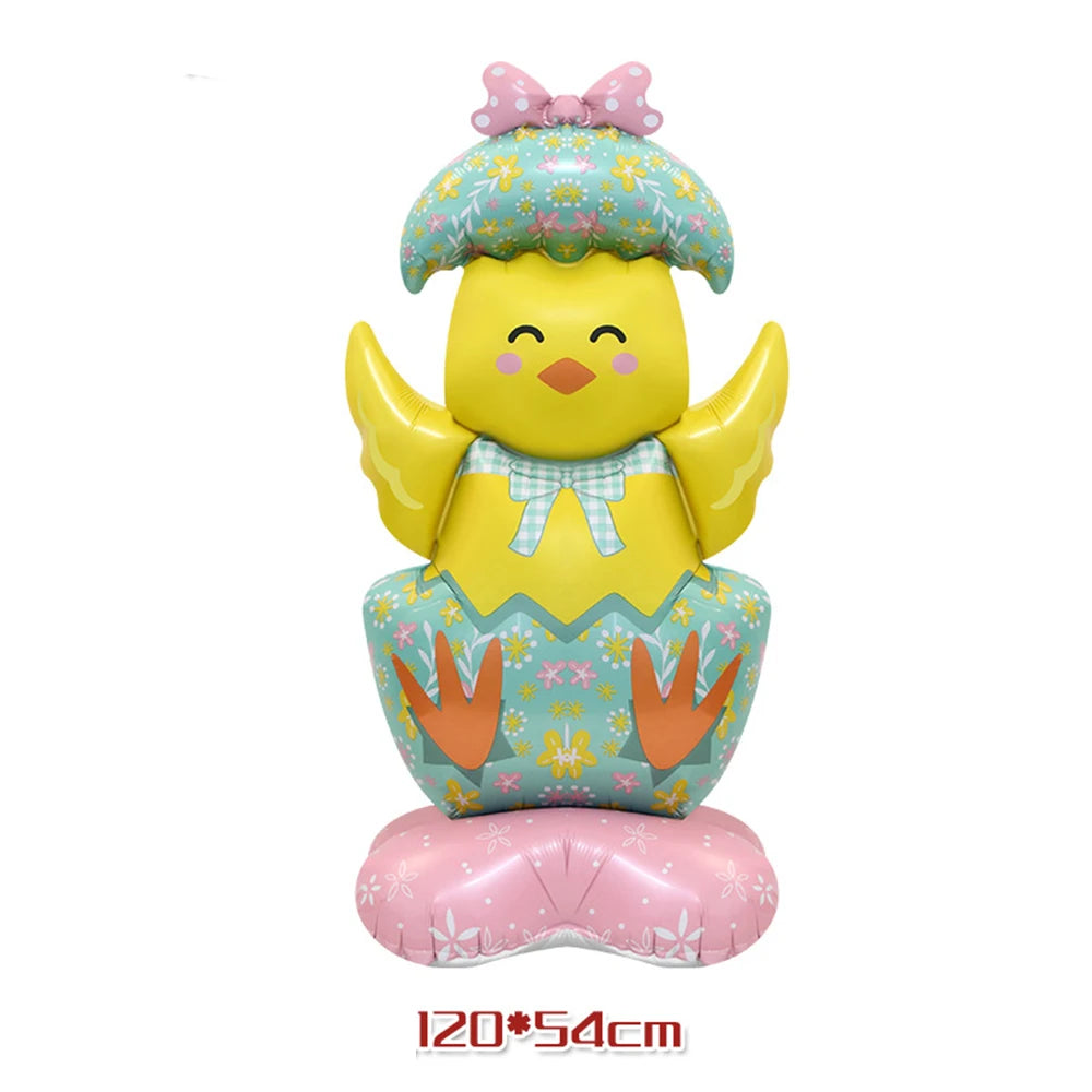 A yellow cartoon chick with a floral hat and patterned body sits on a pink base.