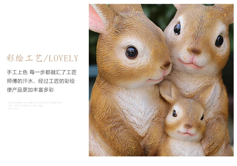Two adorable hand-painted resin rabbit garden statues looking at the camera.