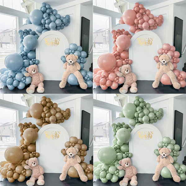 A collection of balloon garlands featuring dusty blue, pink, and green balloons with teddy bear figures for parties.