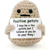 A handmade plush knitting doll resembling a potato with black eyes and a light brown knitted texture.