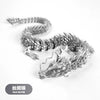 A silver dragon ornament made of silk silver, featuring a coiled body and a detailed head.