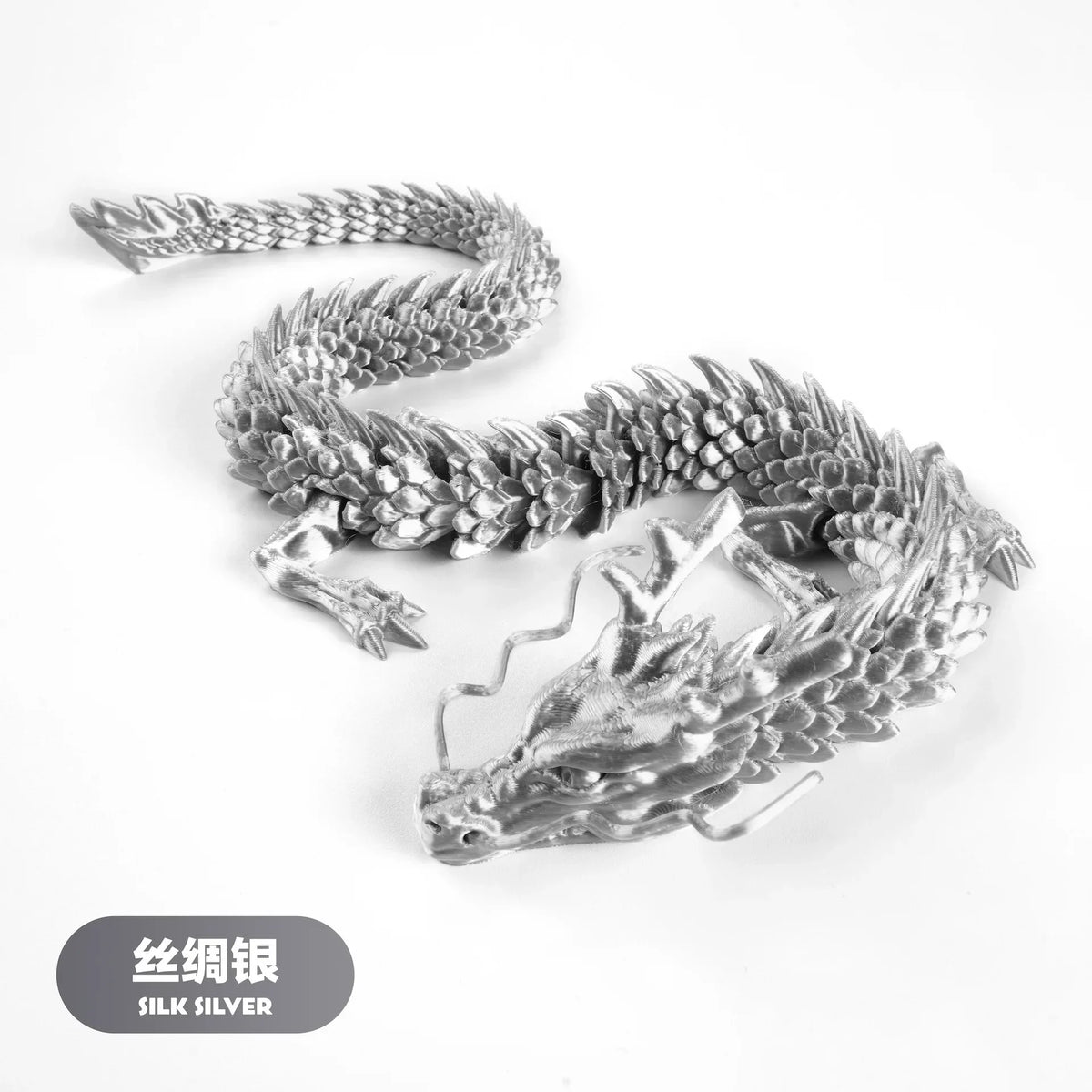 A silver dragon ornament made of silk silver, featuring a coiled body and a detailed head.