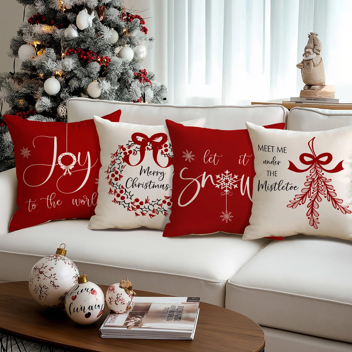 Red Christmas cushion covers featuring white bow and wreath designs on a white sofa.