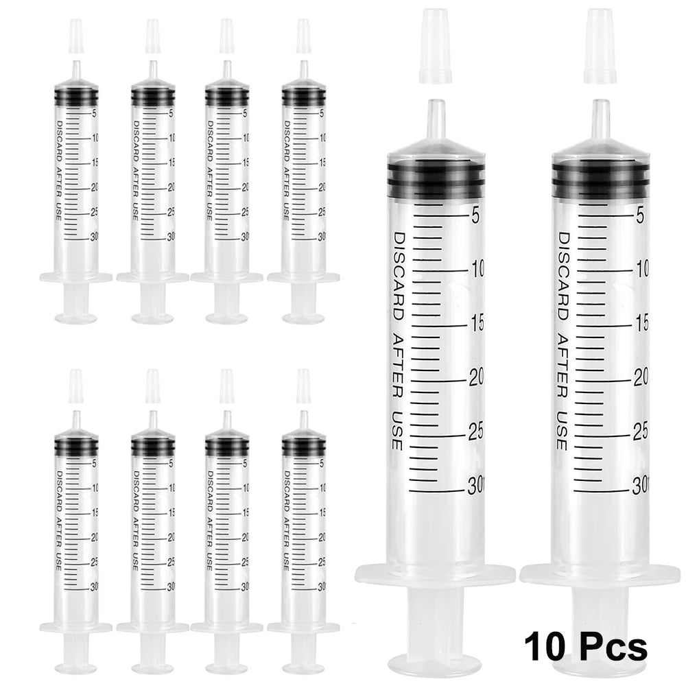 A set of ten clear plastic party syringes with lids for liquid dispensing.