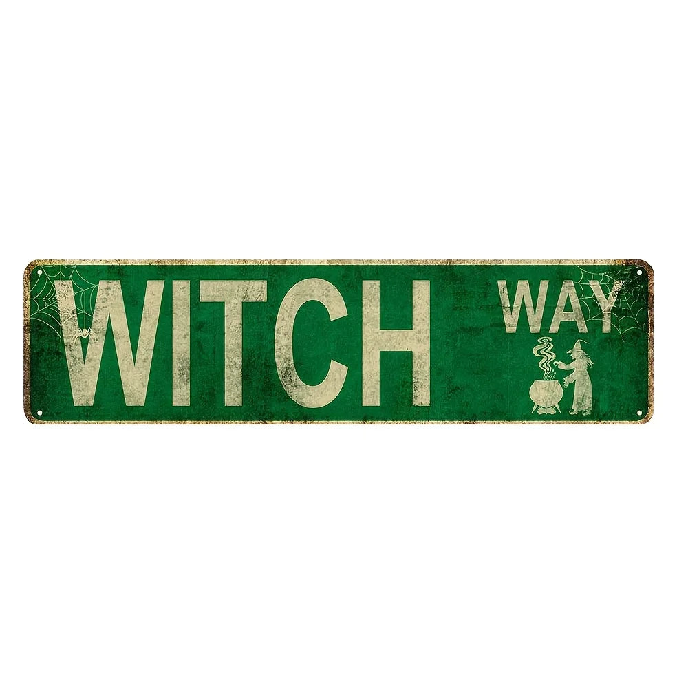 Vintage metal sign with green background and white text reading WITCH WAY featuring a silhouette of a witch.