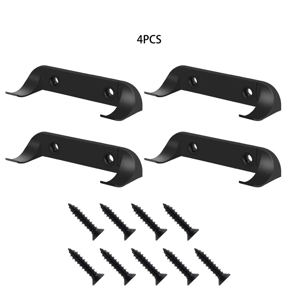 Four black wall mount display holders for die-cast car models and several small screws.