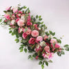 A lush floral arrangement of pink and white artificial roses and greenery for event decor.