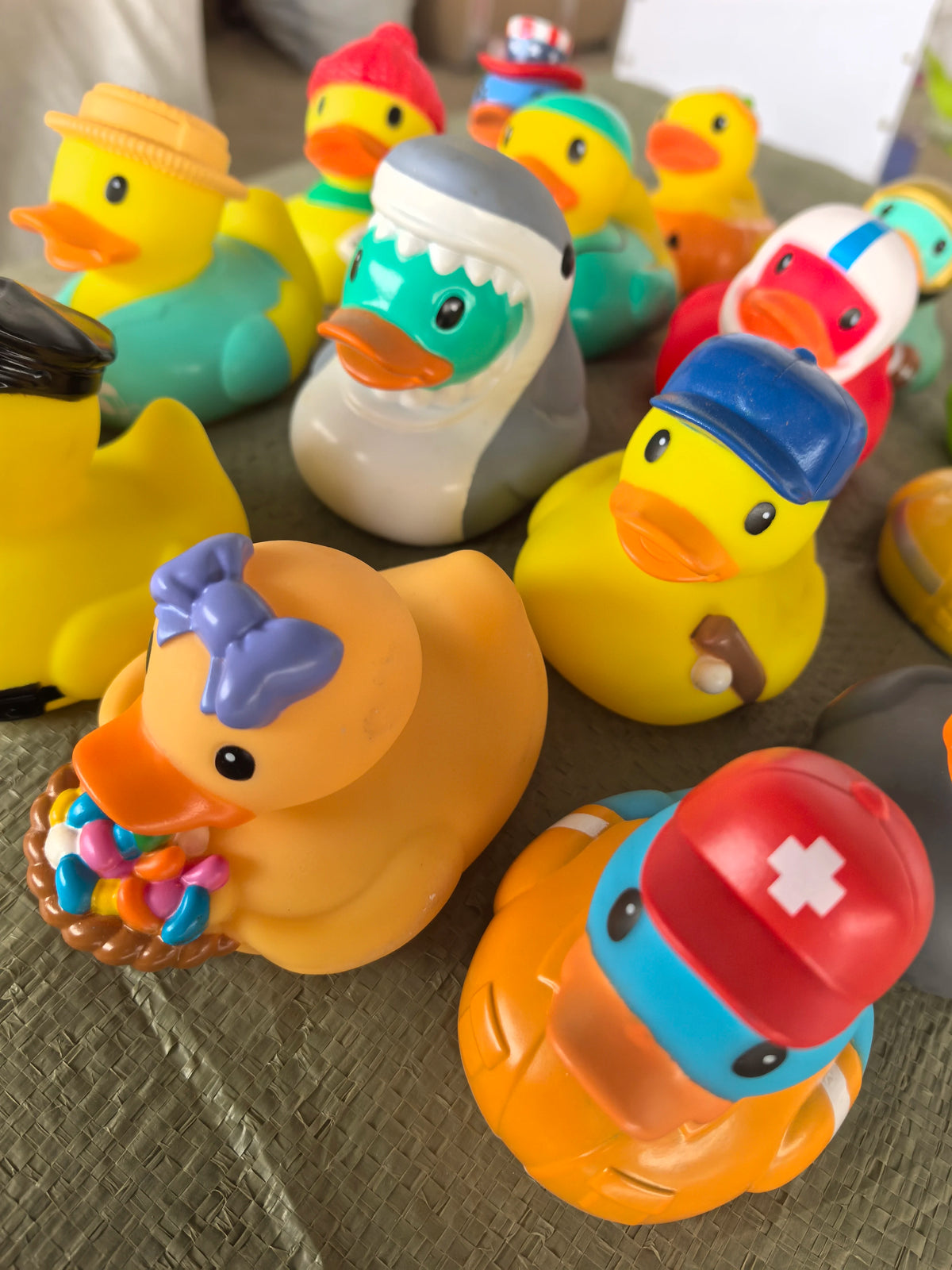 A collection of colorful rubber duck bath toys in various shapes and colors.