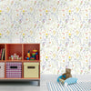 A wooden shelf unit displaying colorful storage boxes against a floral wallpaper background.