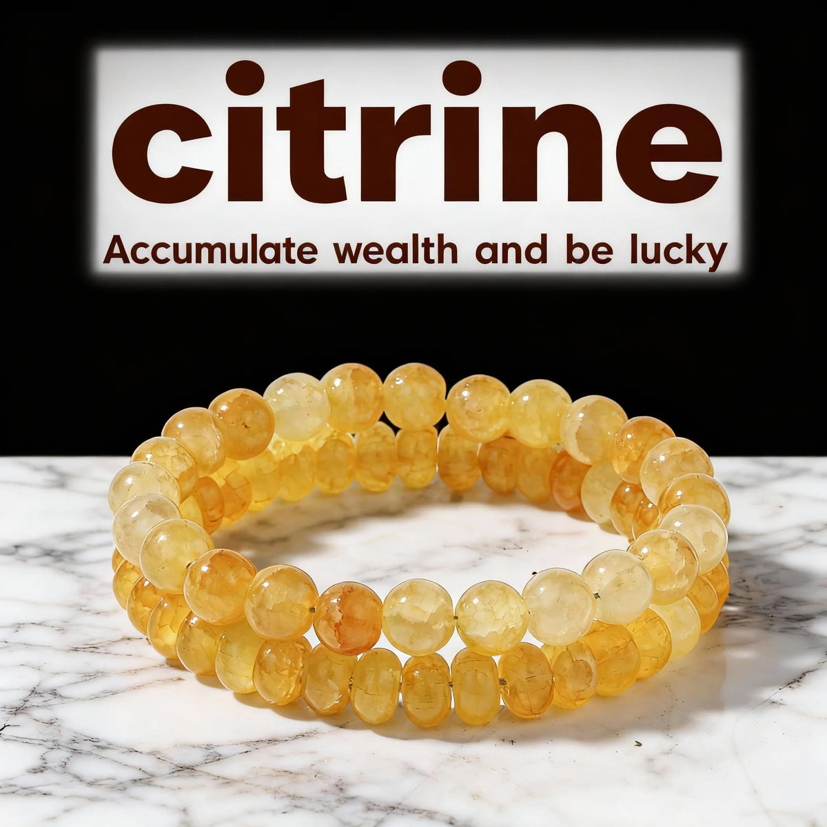 A stack of golden citrine crystal beaded bracelets displayed on a white marble surface.