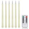 A set of six white flamed taper candles with glass tops shown standing upright.