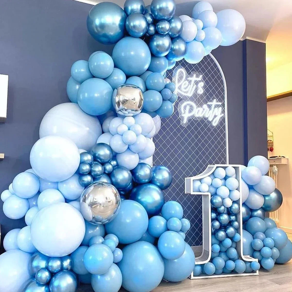 A blue balloon garland arch kit featuring various shades of blue and silver balloons for a party decoration.