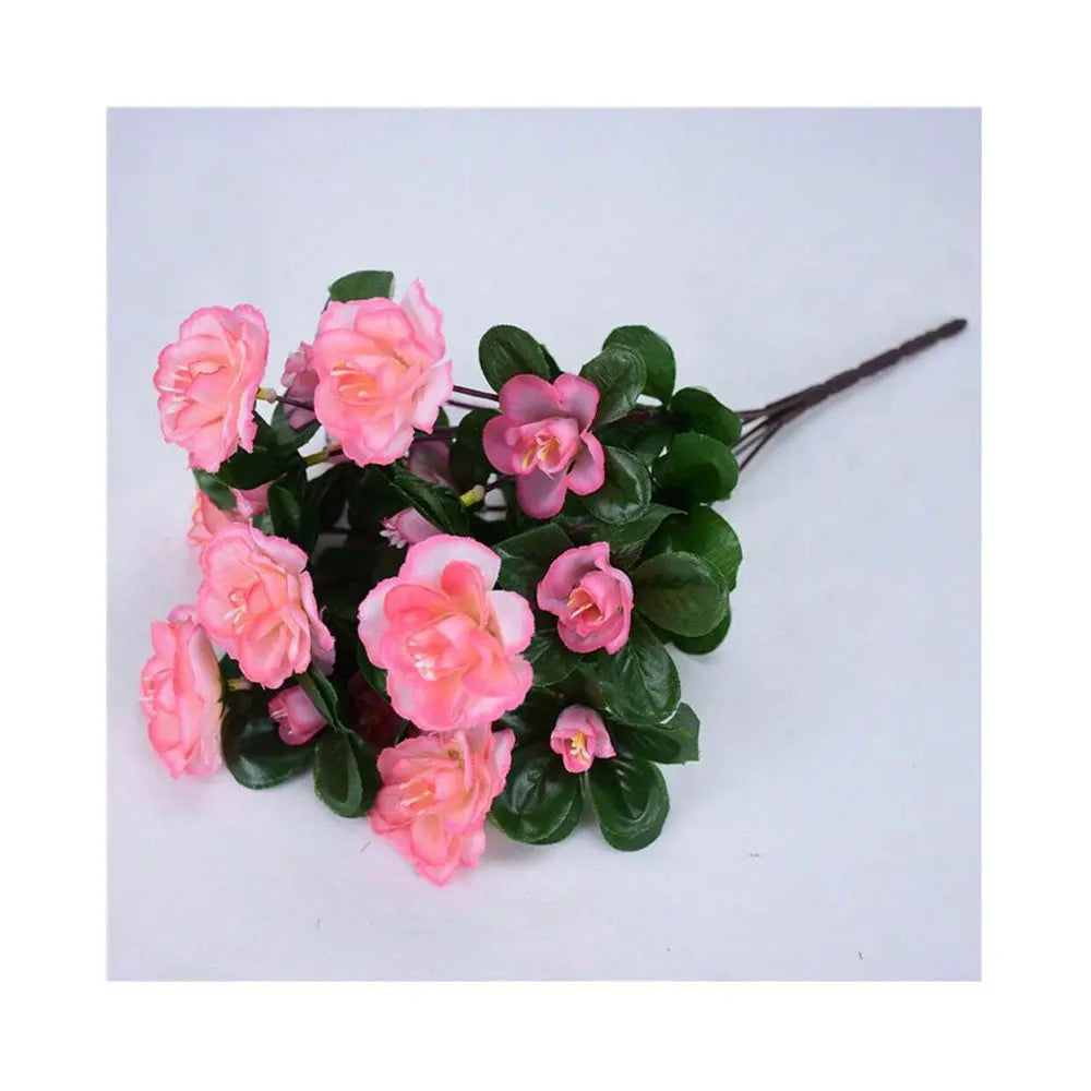 A cluster of pink and coral artificial azalea flowers on green leaves.