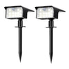 A pair of black solar powered motion sensor spot lights with LED illumination.