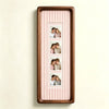 A vertical wooden photo strip frame with a light pink striped background displaying five small portrait photos.