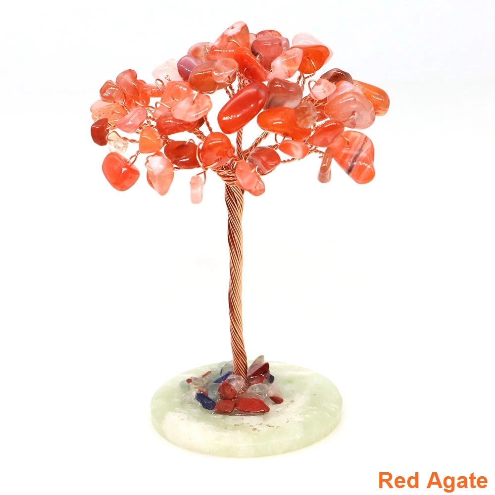 A natural crystal money tree decor featuring reddish-orange translucent beads on a copper wire stem and a light green base.