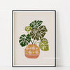 Botanical philodendron canvas wall art featuring a green plant in an orange patterned pot.
