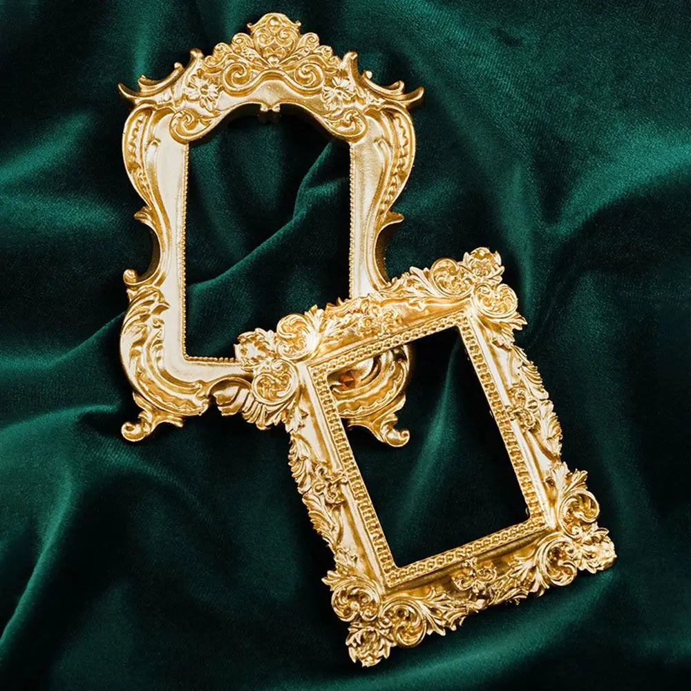 A vintage gold DIY shadow box frame with ornate carvings displayed against a dark green velvet background.