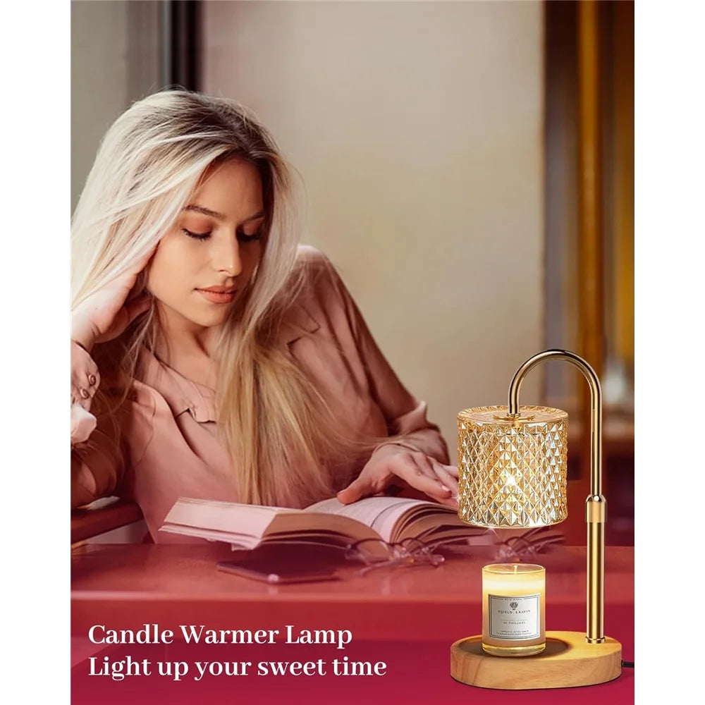 A close-up of a gold candle warmer lamp with a glass jar and wooden base resting on a red surface.