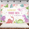 A pink and green cartoon dinosaur backdrop featuring a T-Rex, dinosaur silhouettes, and tropical leaves for a party decoratio