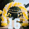 A large marquee sign shaped like the number 16 made of white light bulbs is displayed within a yellow and white balloon archw