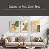 A gallery wall featuring three abstract botanical canvas prints in muted greens, yellows, and beige tones.