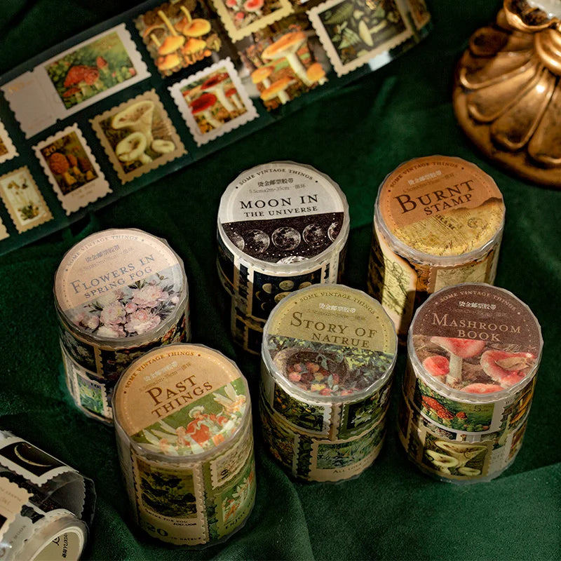 A collection of jars filled with decorative washi tape featuring various themes like flowers, moon, and mushroom