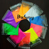 A collection of 13 vivid neon fluorescent pigment powders in various colors like orange, yellow, green, pink, and blue, packa