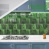 A modern kitchen interior featuring green tile backsplash and gray countertops with stainless steel appliances.
