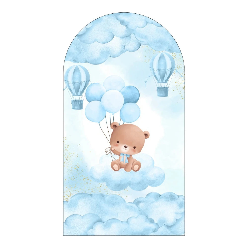 Watercolor illustration of a cute teddy bear floating among blue balloons and hot air balloons against a light blue sky backd