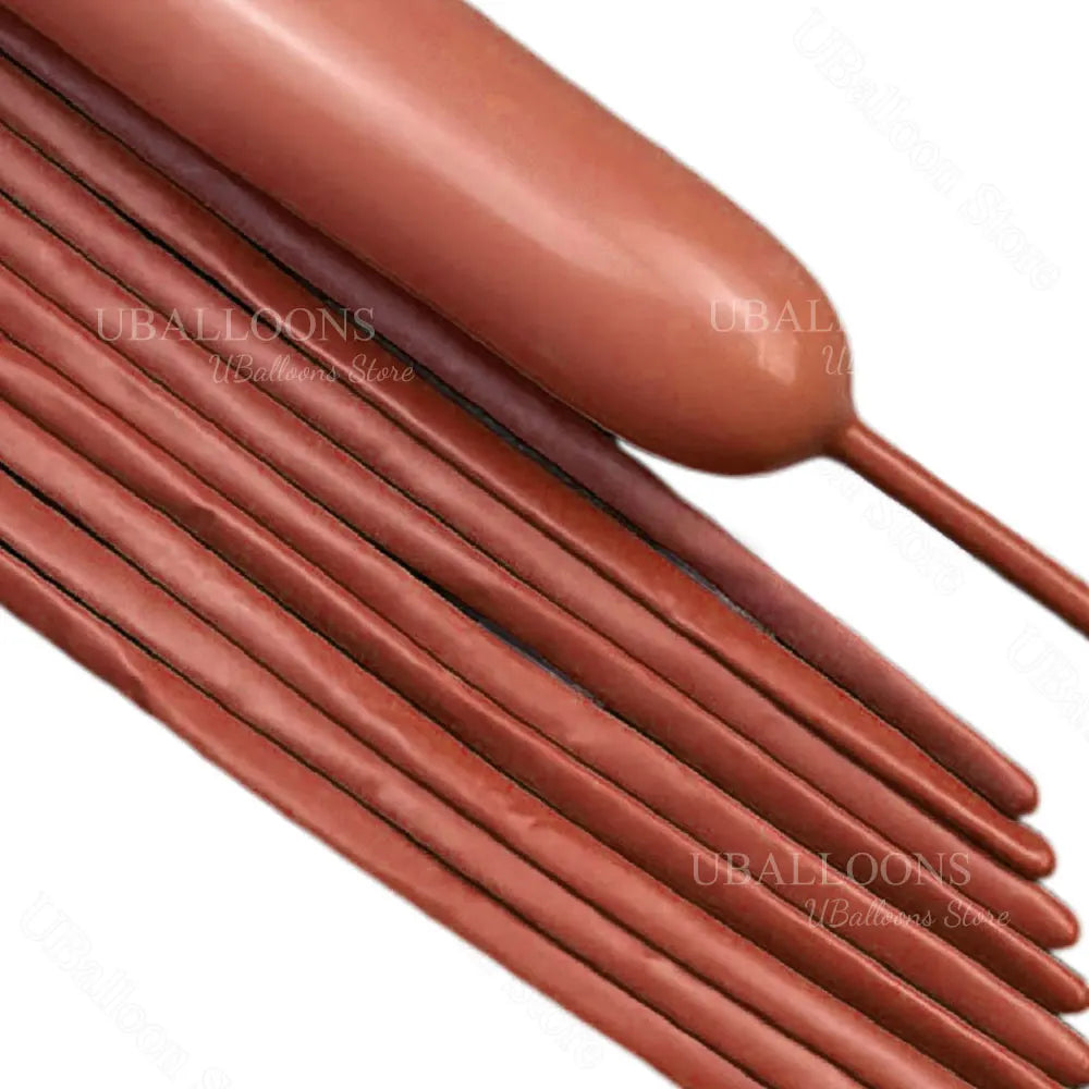 A close-up view of several reddish-brown magic twisting balloons arranged in a row.