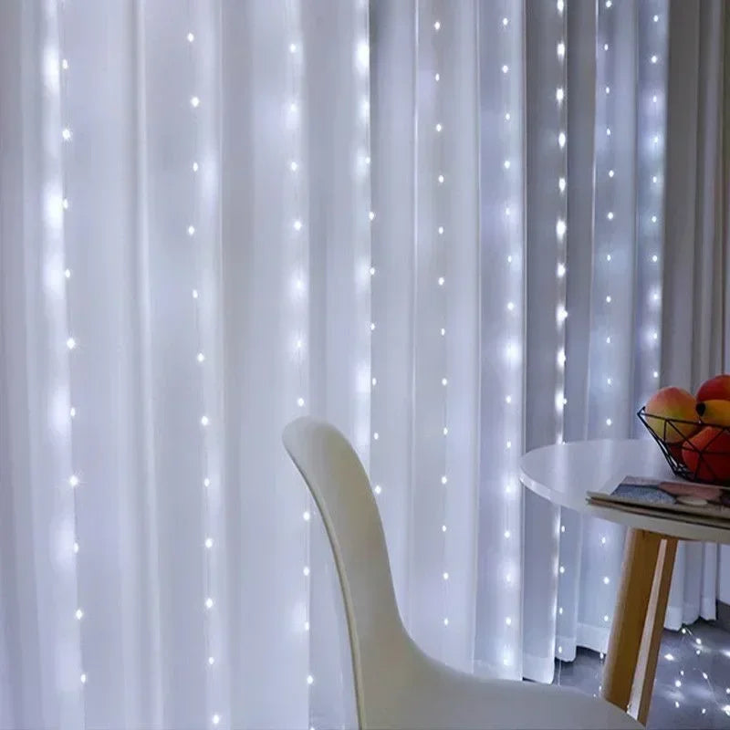 White sheer curtains decorated with vertical strings of twinkling white LED fairy lights.