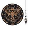 A black wooden pendulum board featuring a geometric design and text like YES, MAYBE, NO, REPHRASE, and a winged insect symbol