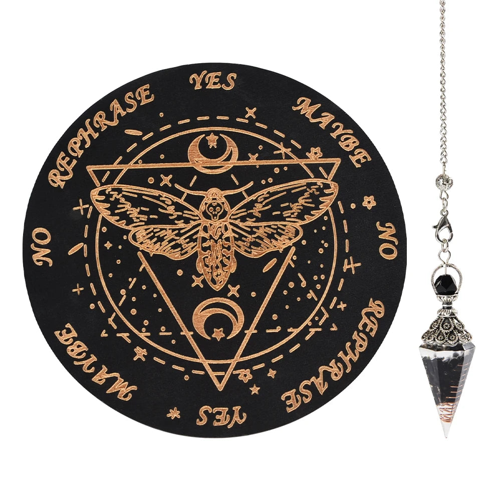 A black wooden pendulum board featuring a geometric design and text like YES, MAYBE, NO, REPHRASE, and a winged insect symbol