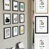 A collection of rustic wooden photo frames in black and white displaying various images, including a welcome sign.