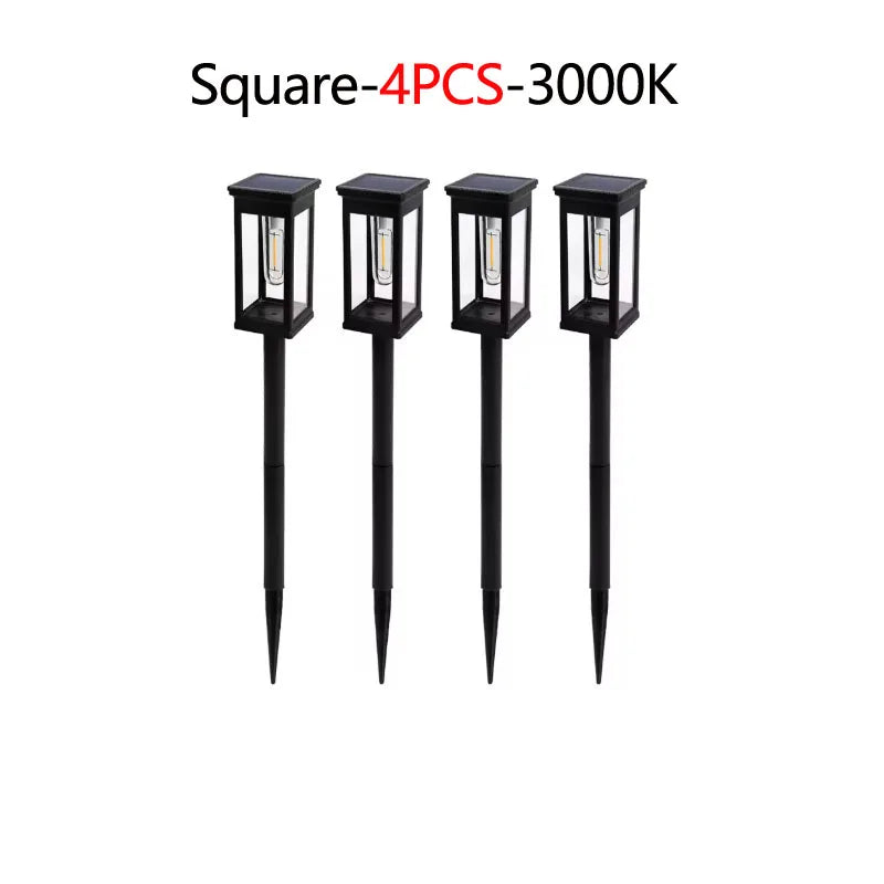 Four black square solar pathway lights with illuminated bulbs for outdoor decor