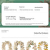 A display of artificial maple leaf garlands in various autumn colors and shades.