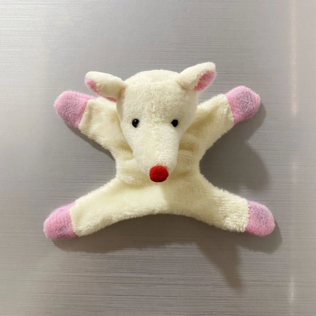 A cute white elephant fridge magnet with pink accents.